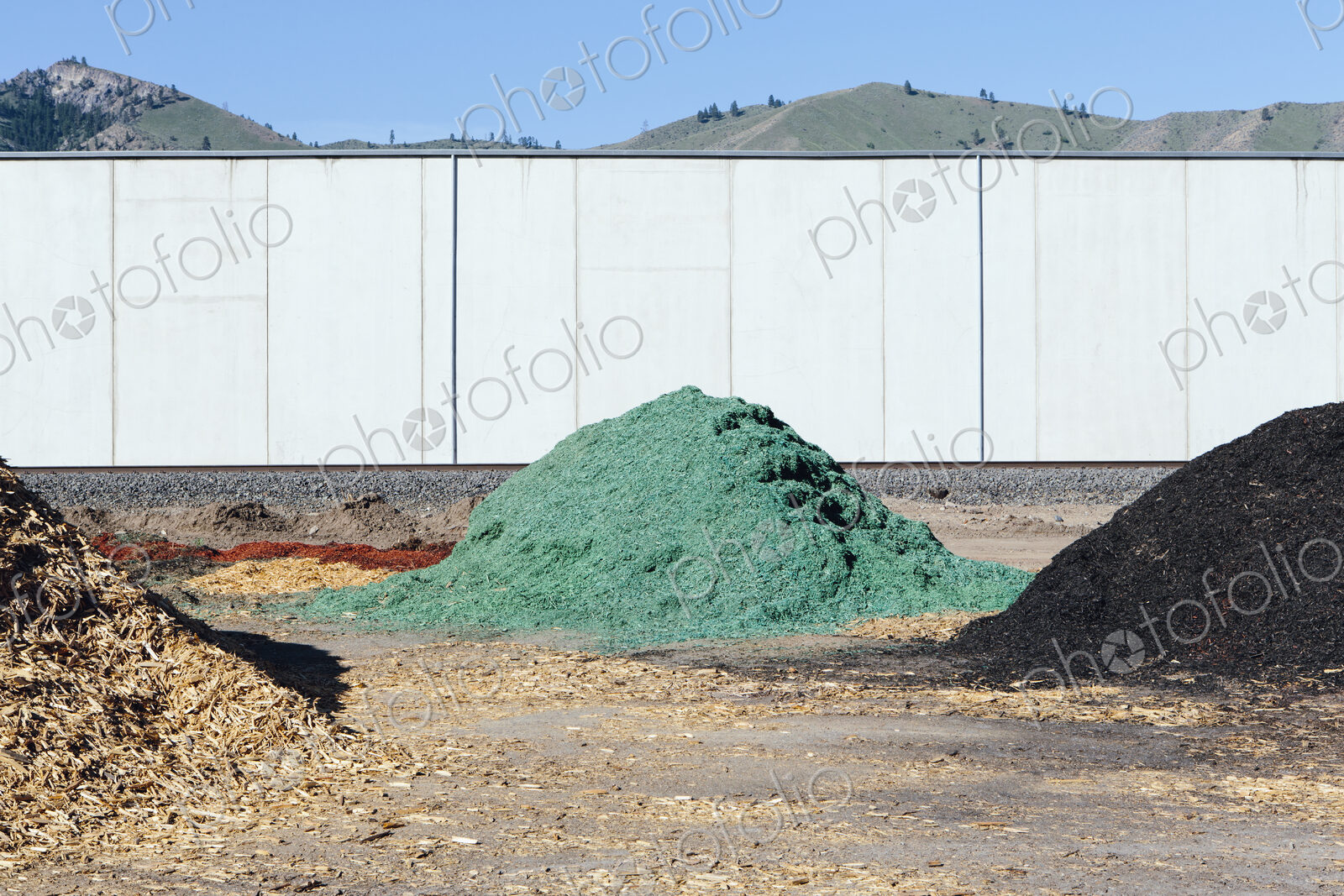 Piles of green bark wood chips used for landscaping, near Quincy