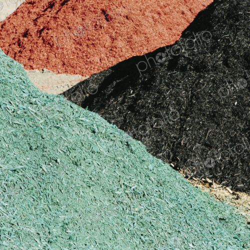 Piles of multi-colored bark wood chips used for landscaping, near Quincy