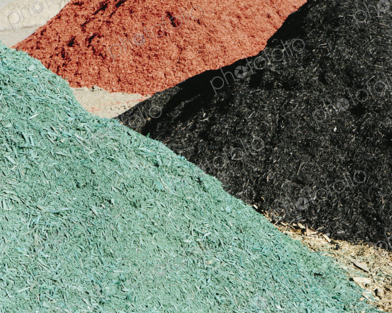Piles of multi-colored bark wood chips used for landscaping, near Quincy