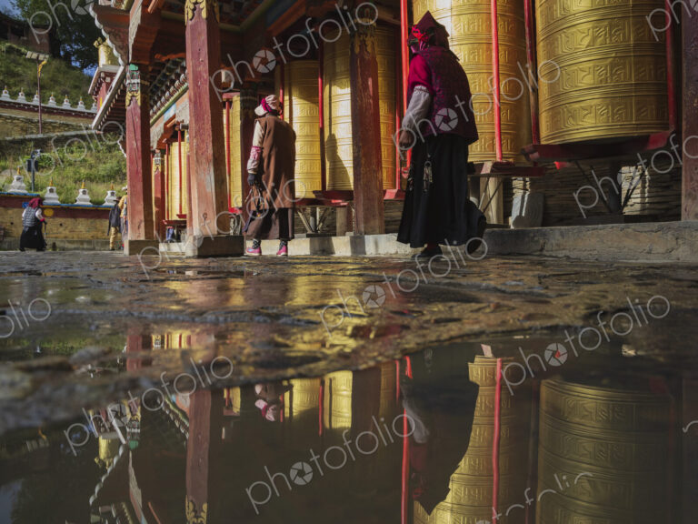 Pilgrims walking around Prayer Wheels Tagong, Sichuan Province, Kham Tibet,