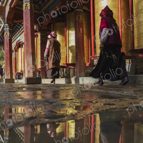 Pilgrims walking around Prayer Wheels Tagong, Sichuan Province, Kham Tibet,