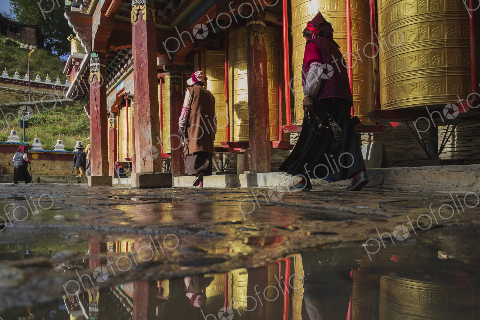 Pilgrims walking around Prayer Wheels Tagong, Sichuan Province, Kham Tibet,