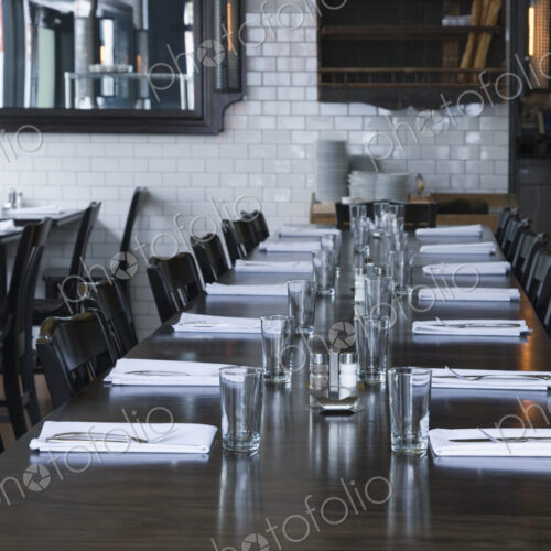 Place settings at table in empty restaurant