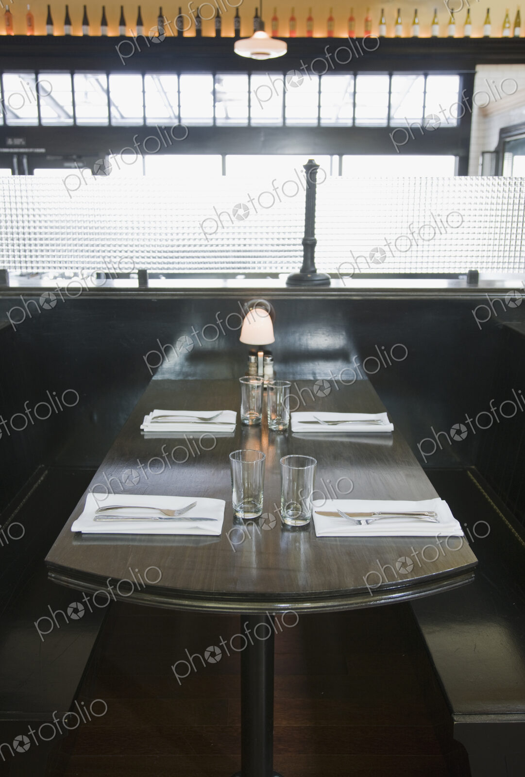 Place settings on empty booth table in restaurant