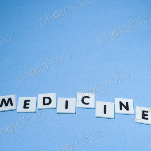 Plastic Letters Spelling out Medicine on a blue background Plastic Letters Spelling out Medicine on a blue background