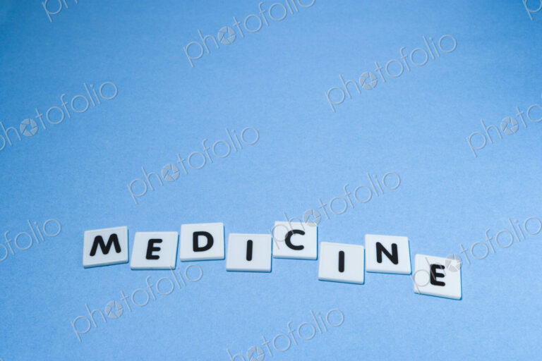 Plastic Letters Spelling out Medicine on a blue background