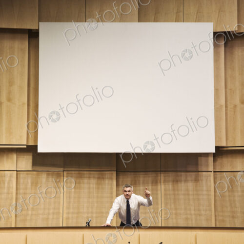 Politician making a speech at a political meeting. Politician making a speech at a political meeting.