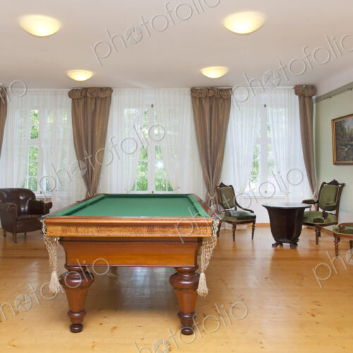 Pool table and furniture in a games room, hotel.