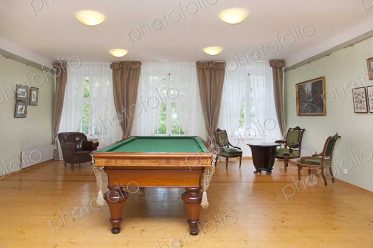 Pool table and furniture in a games room, hotel.