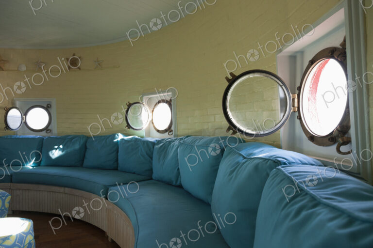 Port hole windows in round lighthouse living room
