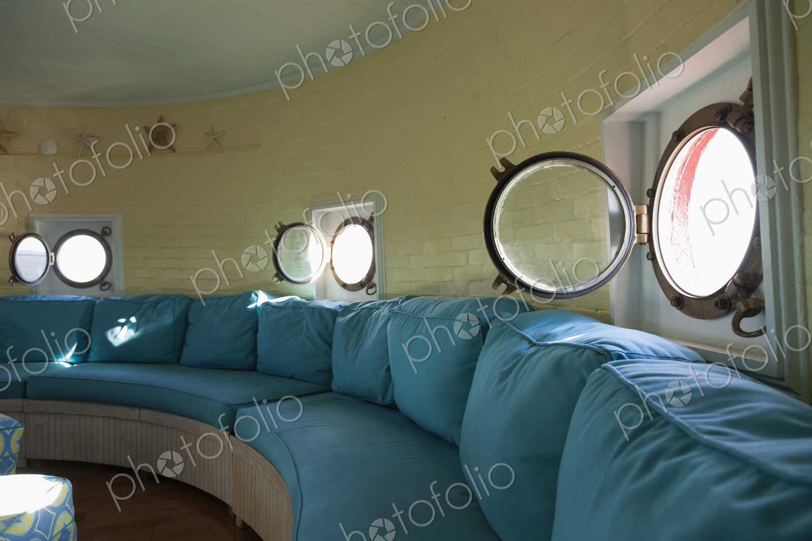 Port hole windows in round lighthouse living room