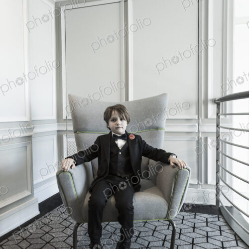 Portrait of 6 year old boy sitting in chair Portrait of 6 year old boy sitting in chair