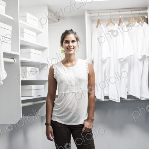 Portrait of HIspanic woman in a closet full of white clothes. Portrait of HIspanic woman in a closet full of white clothes.