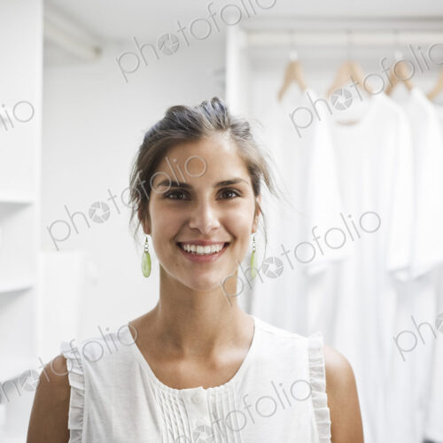 Portrait of HIspanic woman in a closet full of white clothes. Portrait of HIspanic woman in a closet full of white clothes.
