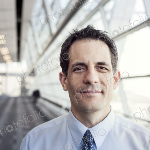 Portrait of a Caucasian businessman in a conference centre lobby.