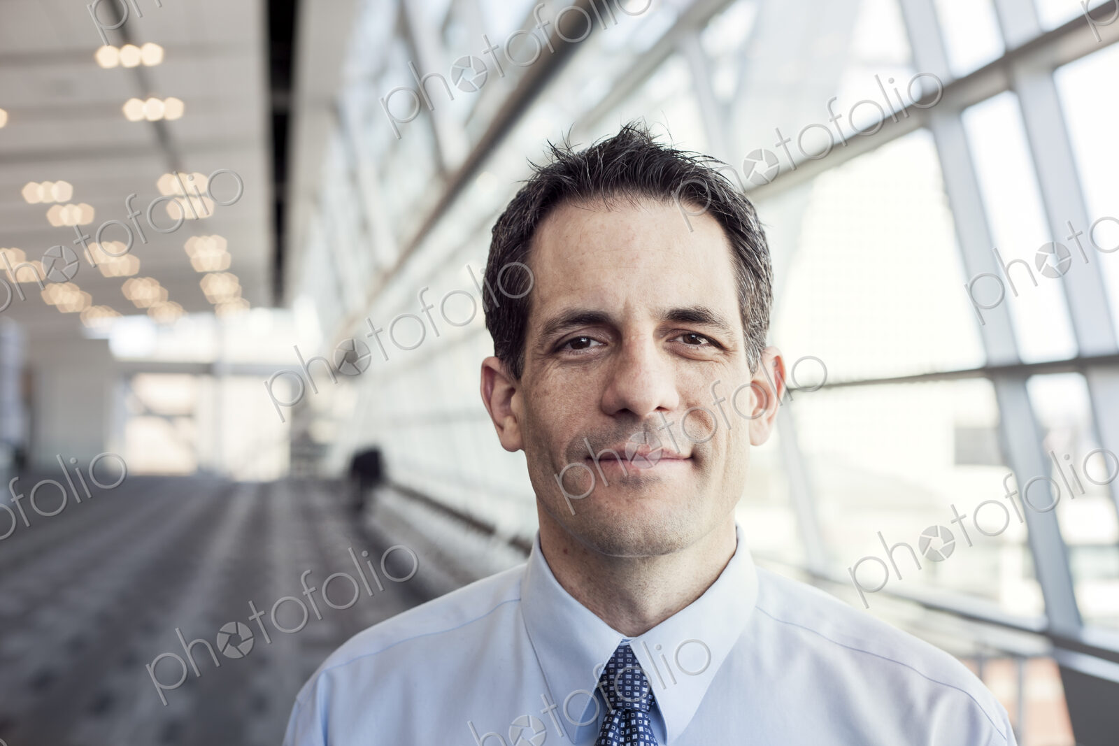 Portrait of a Caucasian businessman in a conference centre lobby.