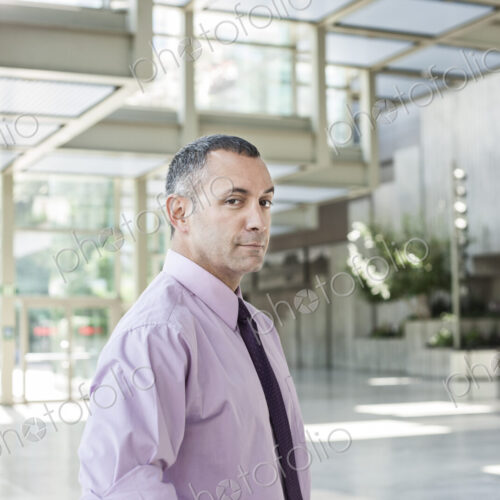 Portrait of a Caucasian businessman in the lobby of a convention center. Portrait of a Caucasian businessman in the lobby of a convention center.