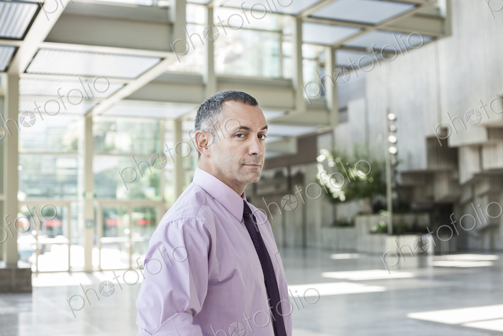 Portrait of a Caucasian businessman in the lobby of a convention center.