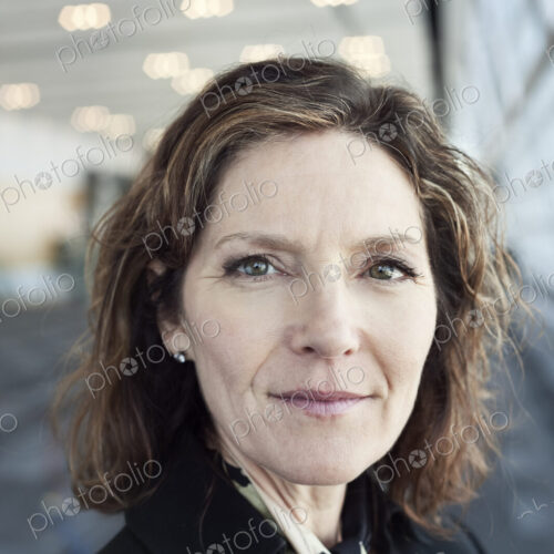 Portrait of a Caucasian businesswoman in a conference centre lobby.