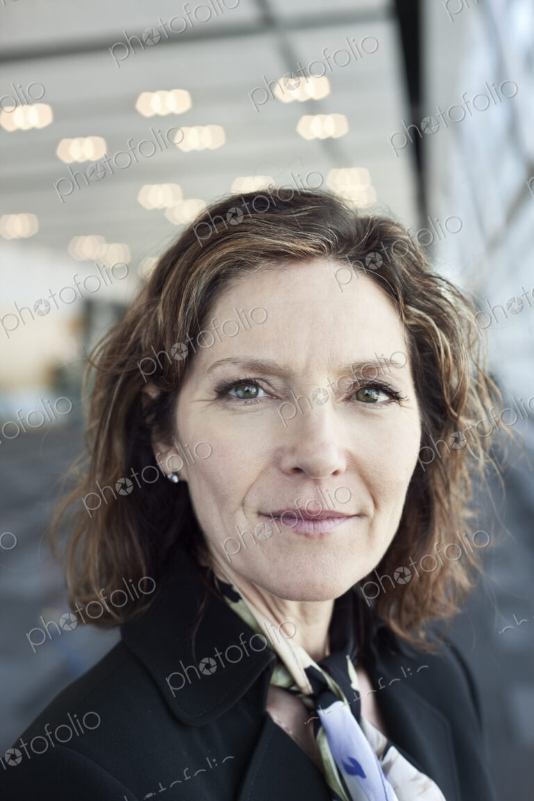 Portrait of a Caucasian businesswoman in a conference centre lobby.