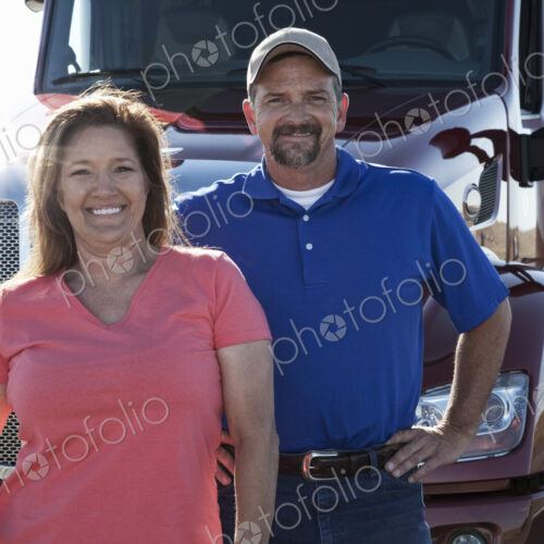 Portrait of a Caucasian husband and wife driving team with their commercial truck. Portrait of a Caucasian husband and wife driving team with their commercial truck.