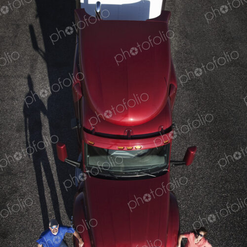 Portrait of a Caucasian husband and wife driving team with their commercial truck. Portrait of a Caucasian husband and wife driving team with their commercial truck.