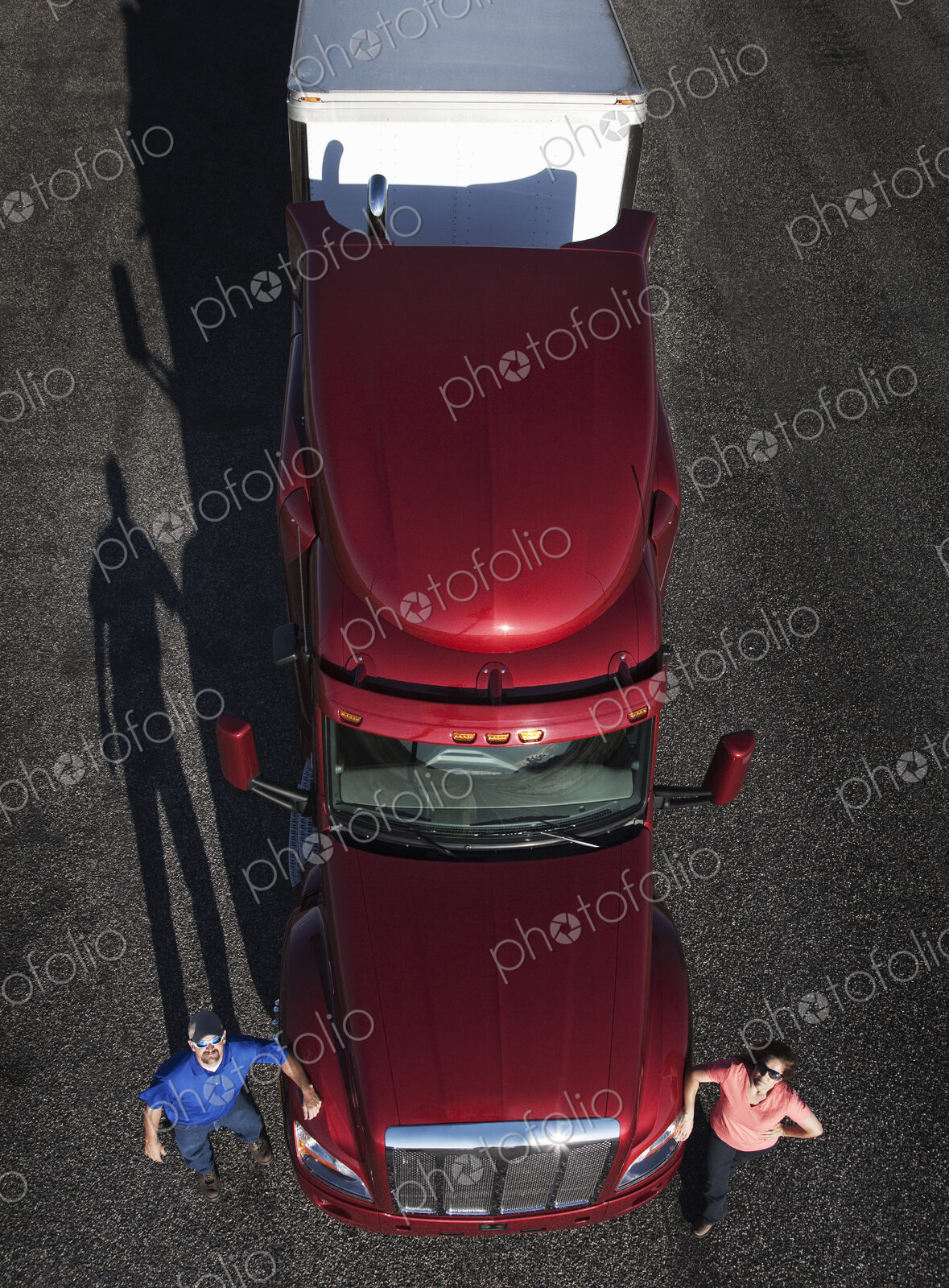 Portrait of a Caucasian husband and wife driving team with their commercial truck.