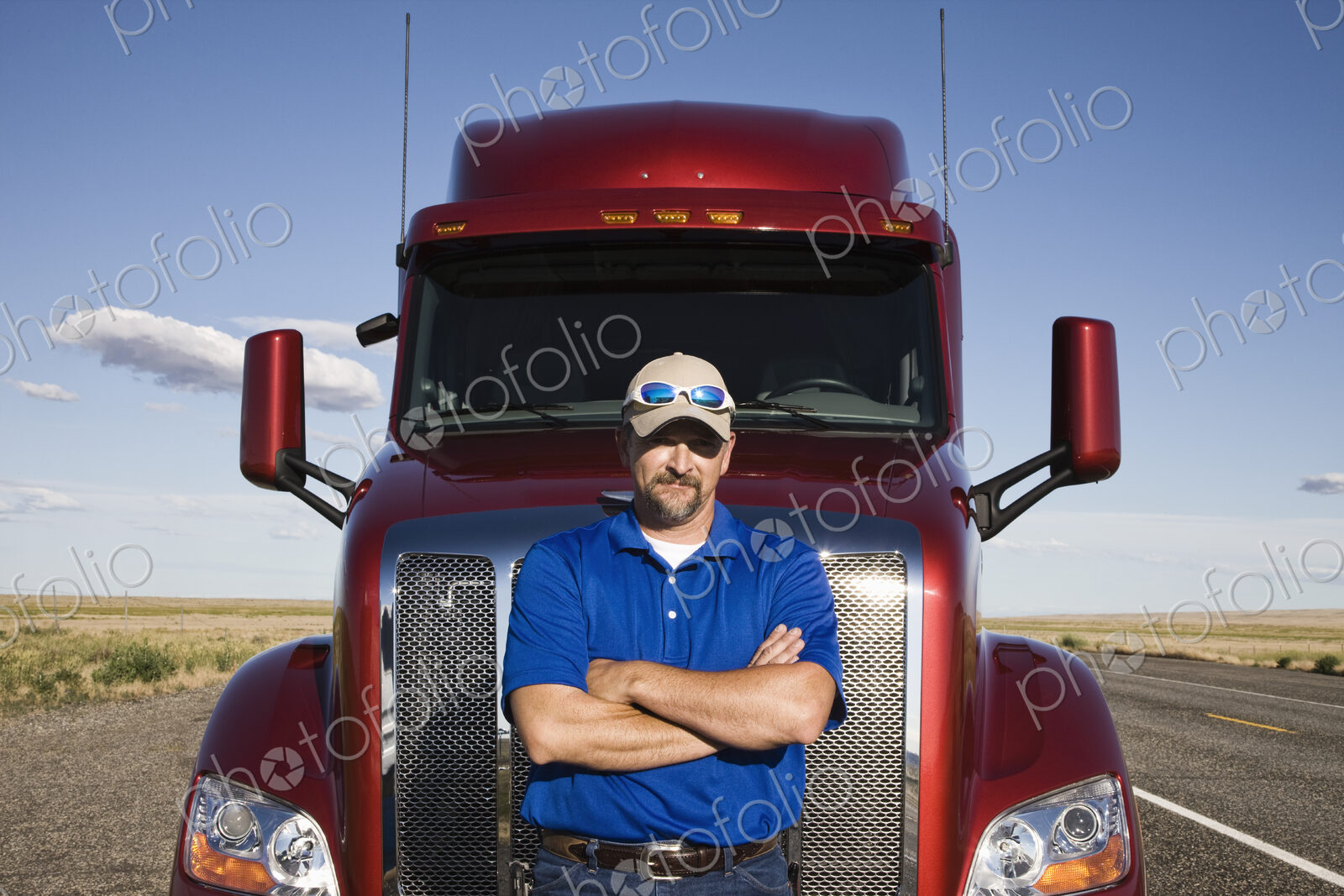 Portrait of a Caucasian man driver and his commercial truck.