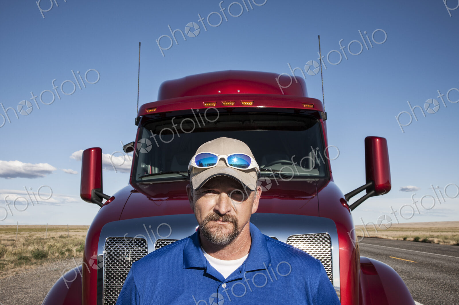 Portrait of a Caucasian man driver and his commercial truck.