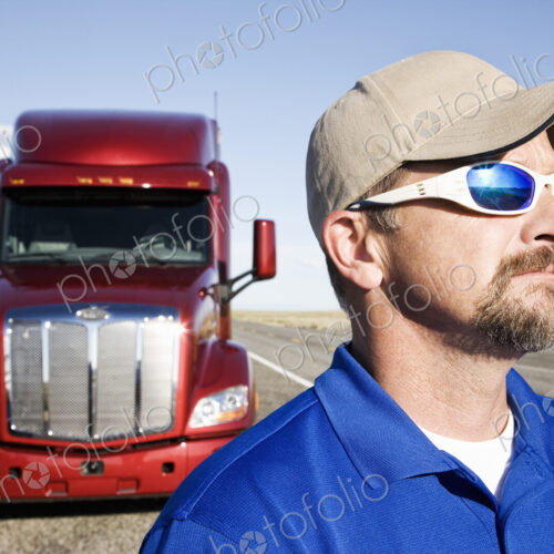 Portrait of a Caucasian man driver and his commercial truck. Portrait of a Caucasian man driver and his commercial truck.