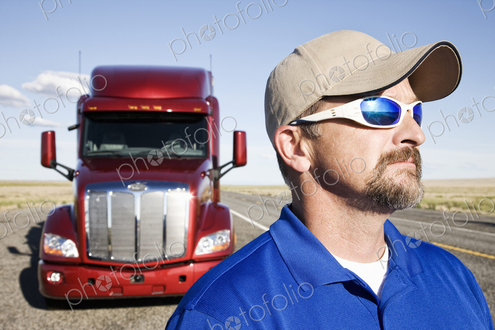 Portrait of a Caucasian man driver and his commercial truck.