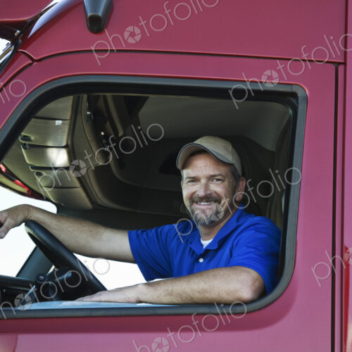Portrait of a Caucasian man driver and his commercial truck. Portrait of a Caucasian man driver and his commercial truck.