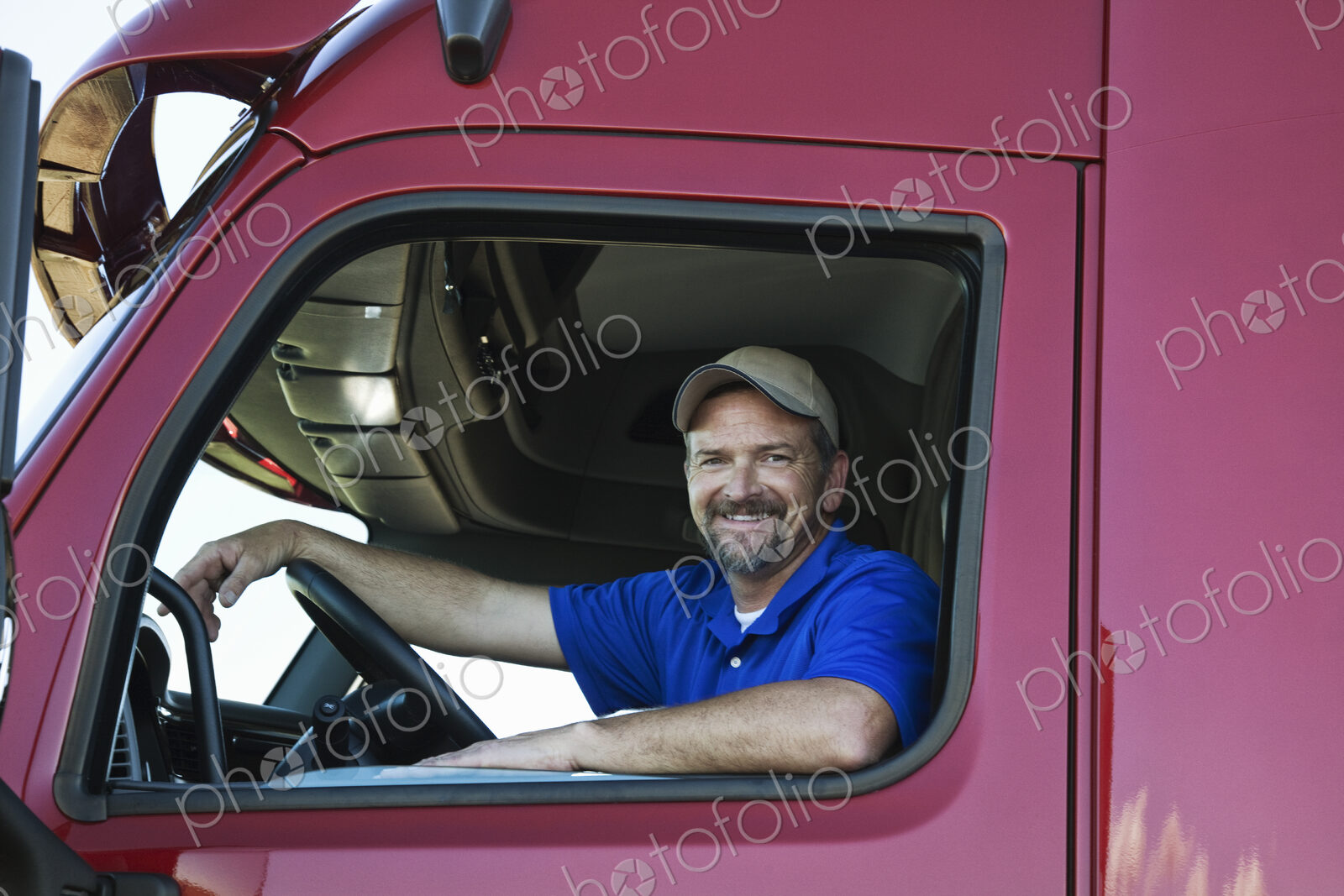 Portrait of a Caucasian man driver and his commercial truck.