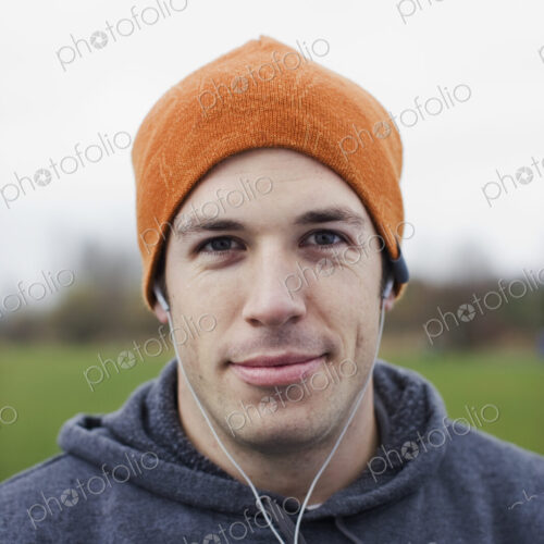 Portrait of a Caucasian man in an orange beanie hat. Portrait of a Caucasian man in an orange beanie hat.