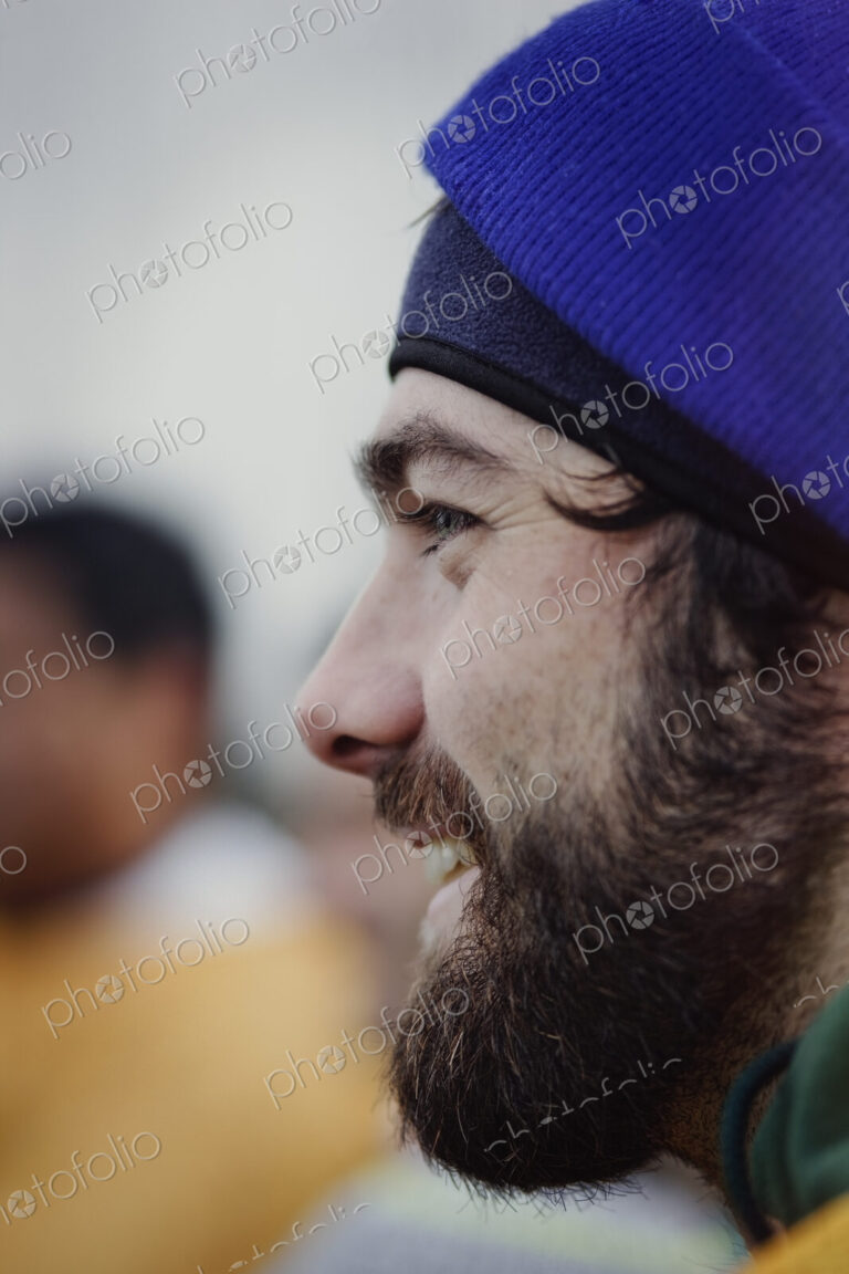 Portrait of a Caucasian man with beard and moustache in a blue hat.