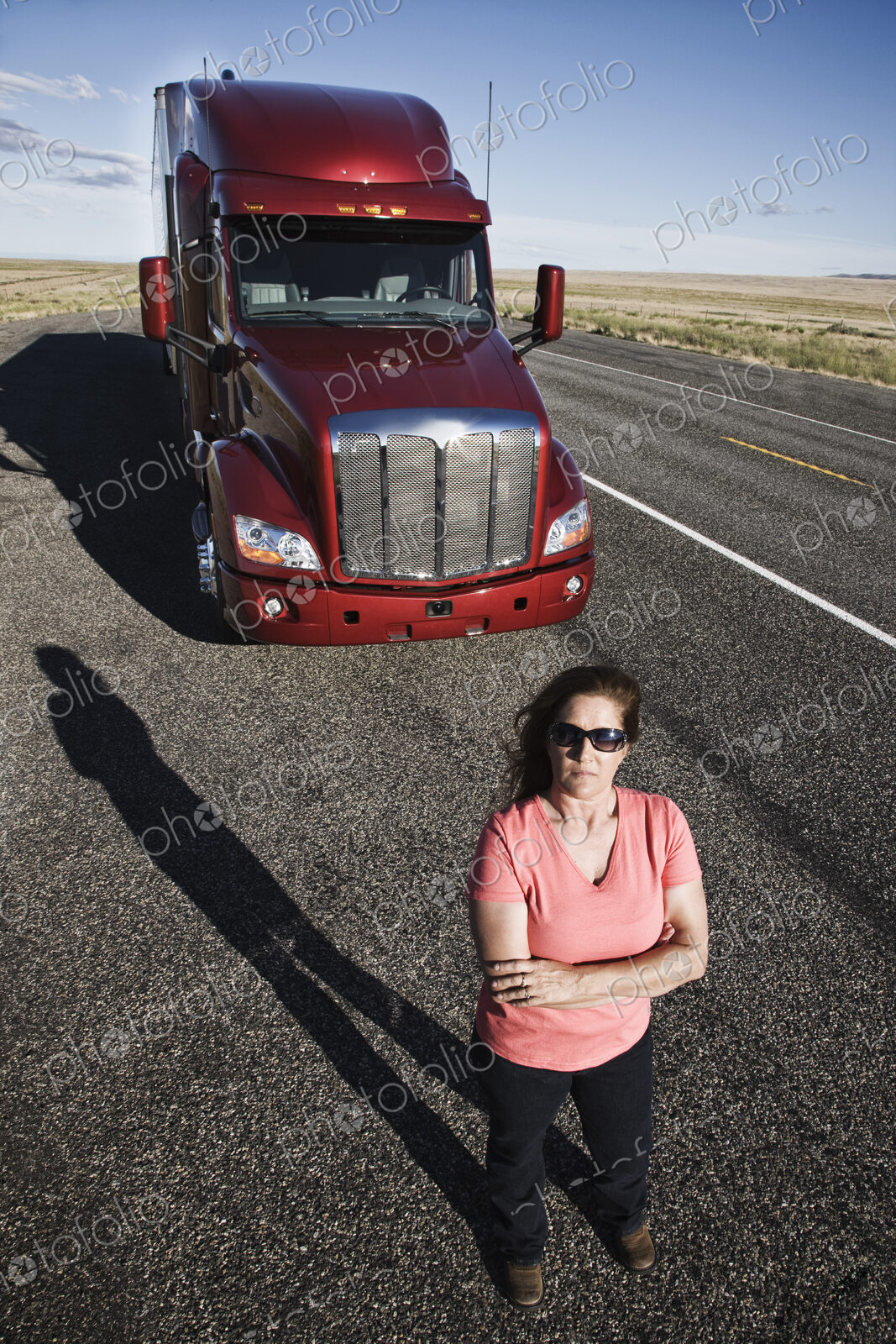 Portrait of a Caucasian woman driver and her commercial truck.
