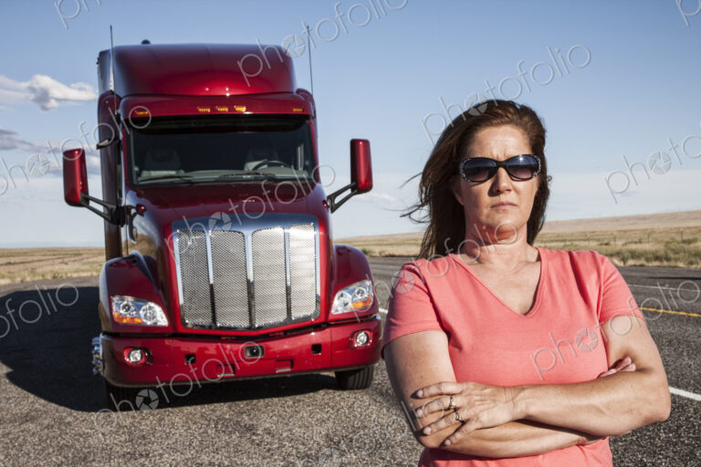 Portrait of a Caucasian woman driver and her commercial truck.
