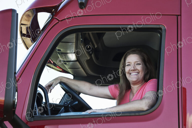 Portrait of a Caucasian woman driver and her commercial truck.