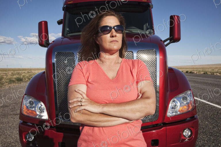 Portrait of a Caucasian woman driver and her commercial truck.