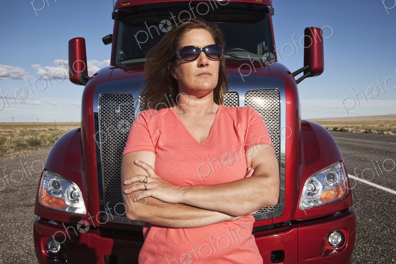 Portrait of a Caucasian woman driver and her commercial truck.
