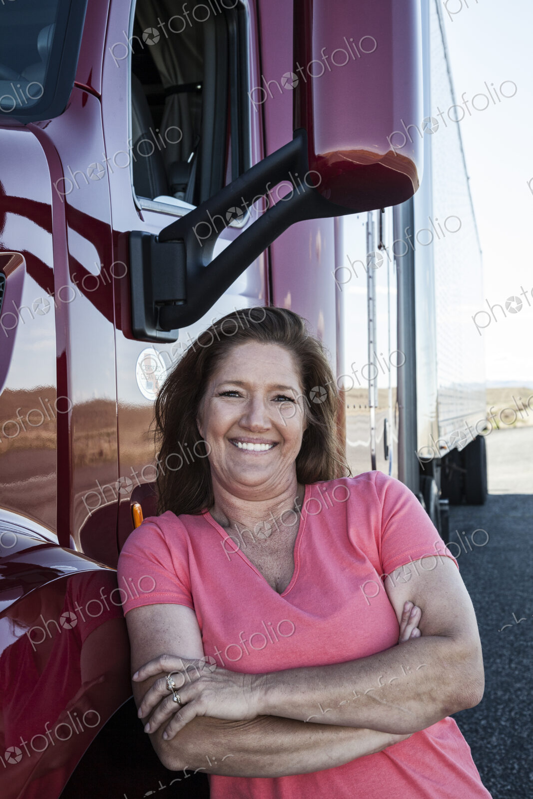 Portrait of a Caucasian woman driver and her commercial truck.