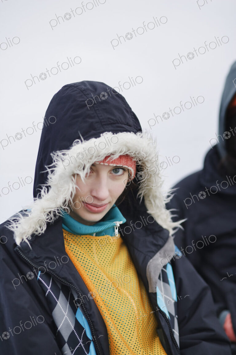Portrait of a Caucasian woman wearing a winter coat with a fur lined hood.