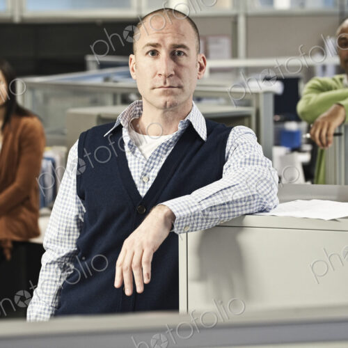 Portrait of a Mixed Race team of three people in an office cubicle setting' Portrait of a Mixed Race team of three people in an office cubicle setting'