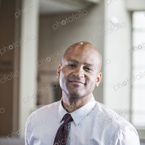 Portrait of a black businessman in the lobby of convention center. Portrait of a black businessman in the lobby of convention center.