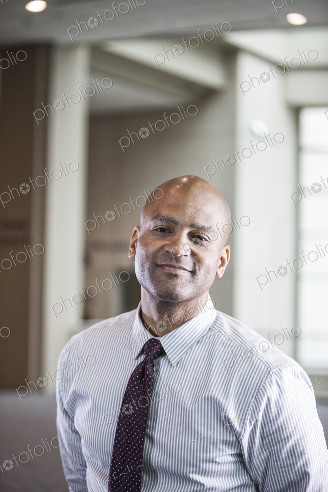 Portrait of a black businessman in the lobby of convention center.