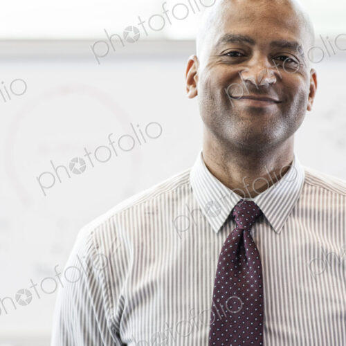Portrait of a black businessman in the lobby of convention center. Portrait of a black businessman in the lobby of convention center.