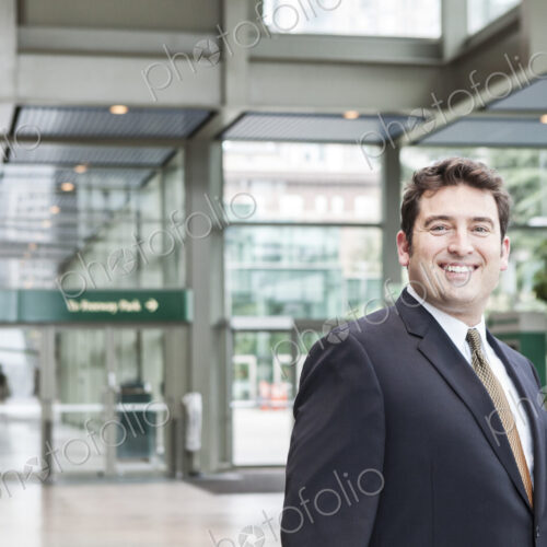 Portrait of a caucasian businessman at a convention center space. Portrait of a caucasian businessman at a convention center space.