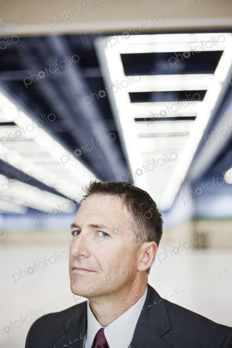 Portrait of a caucasian businessman in a convention center space.