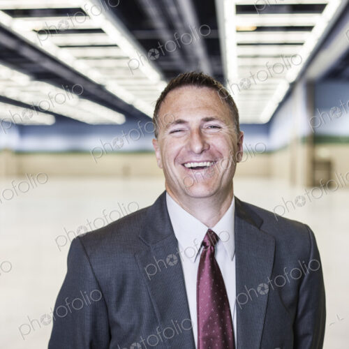 Portrait of a caucasian businessman in a convention center space.