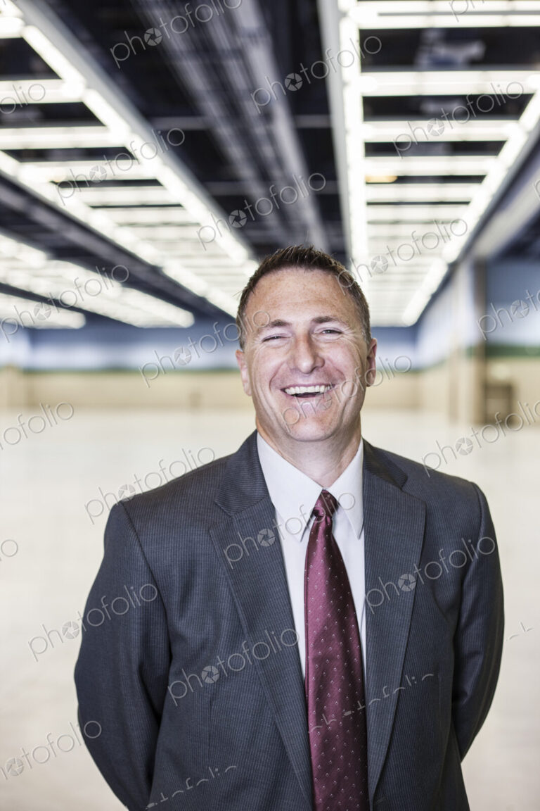 Portrait of a caucasian businessman in a convention center space.